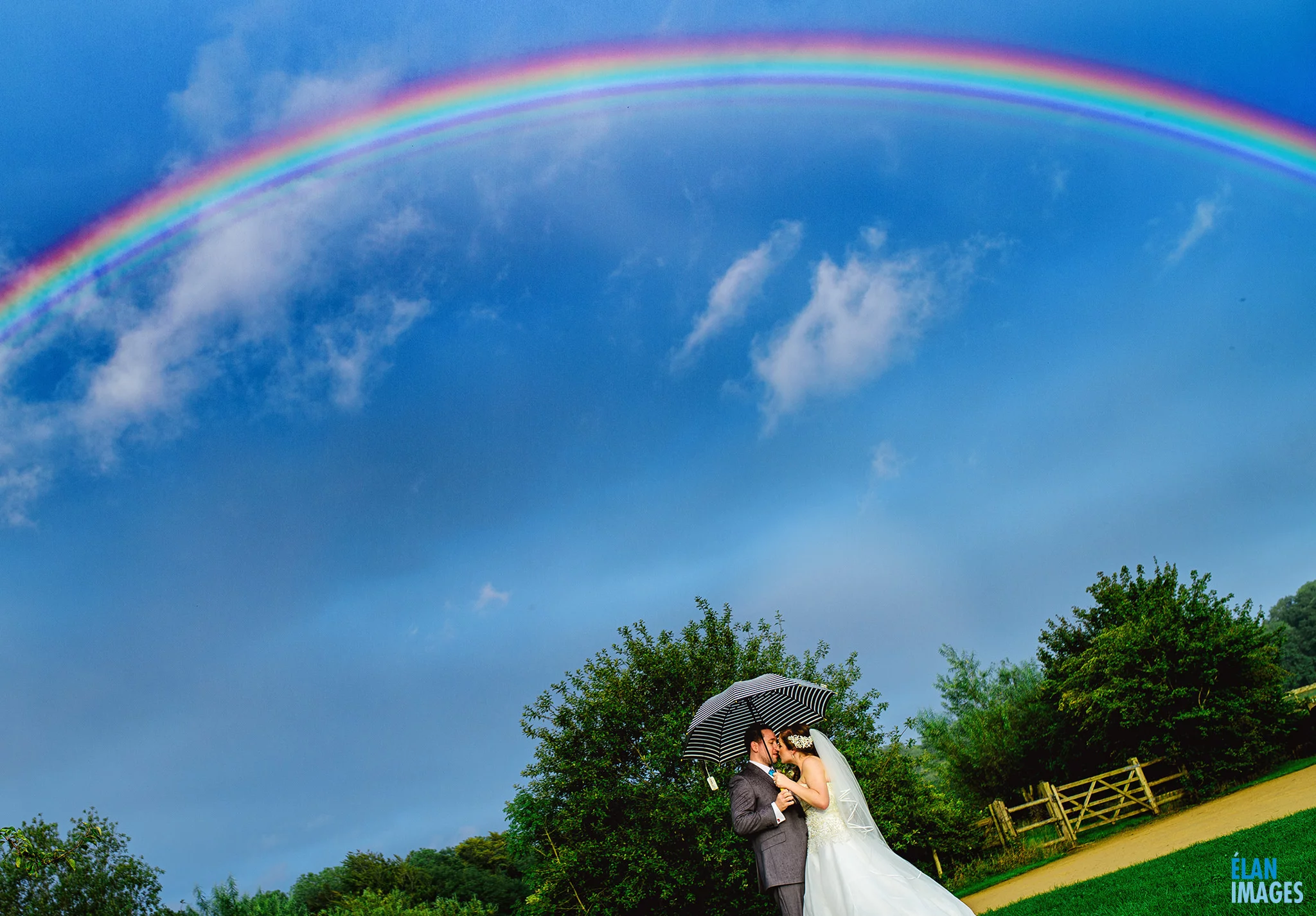 FOLLY FARM CENTRE Wedding - Bride and Groom under a rainbow