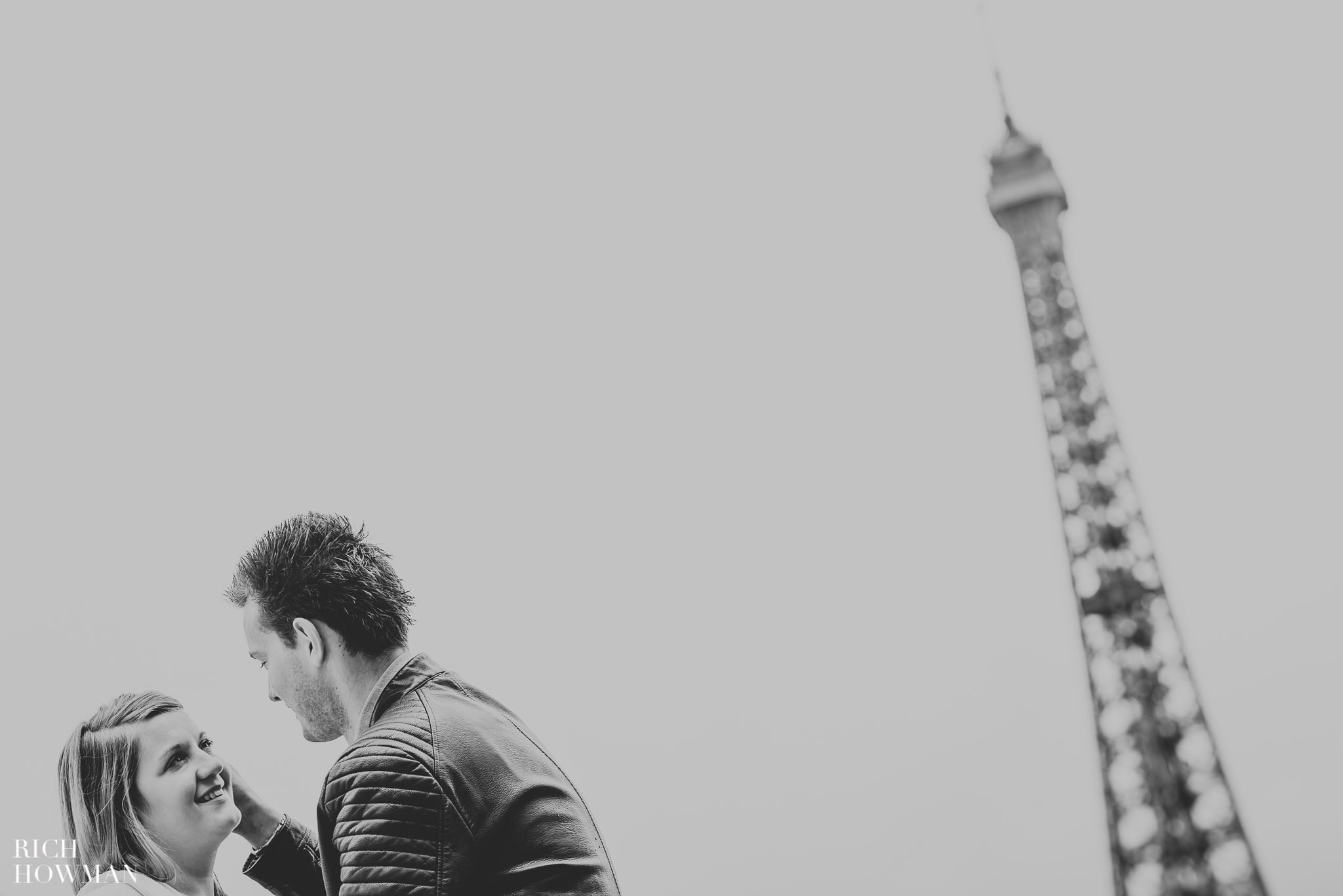 Black and white photograph of a couple at the Eiffel Tower, Paris