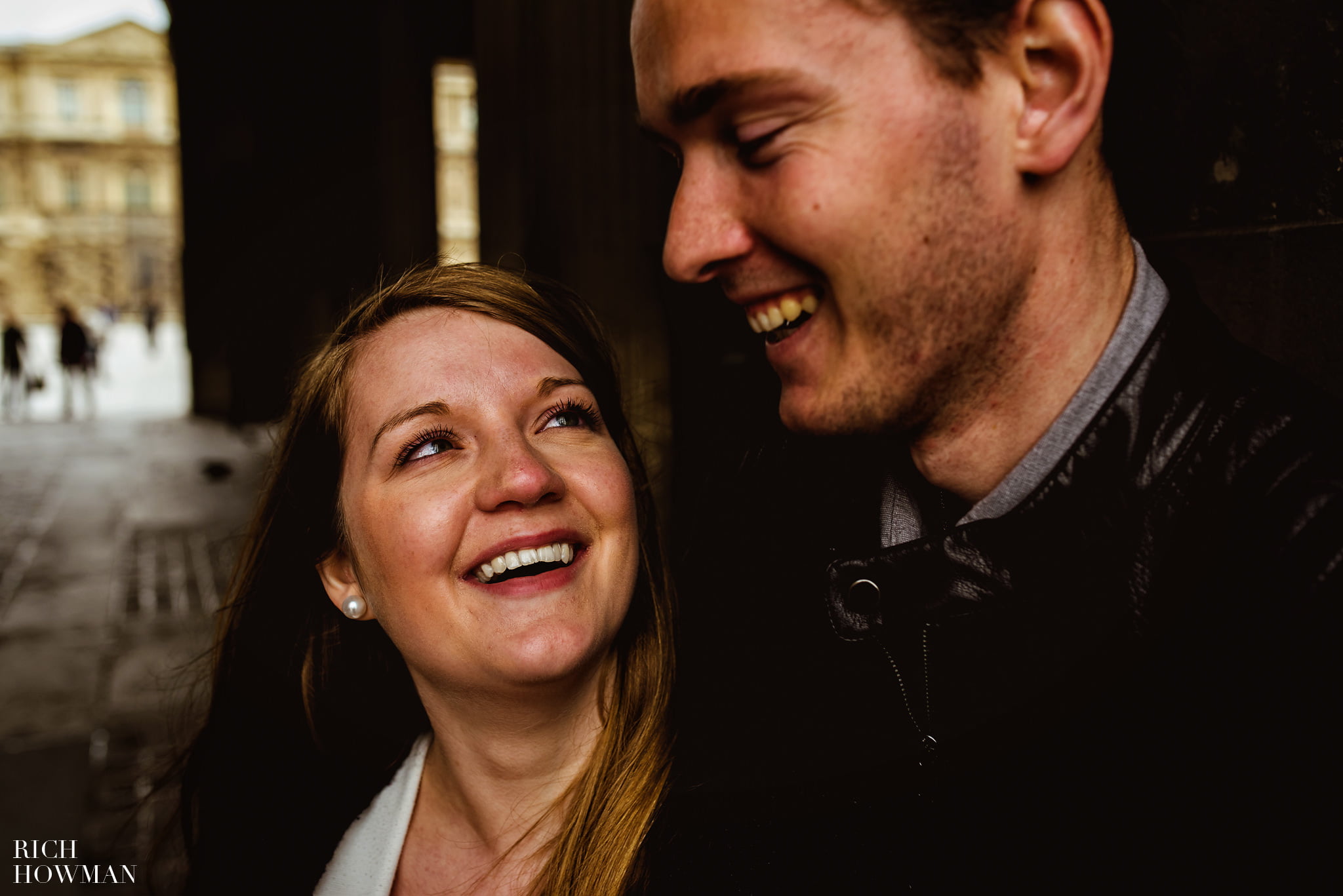 Couple smiling and laughing at La Louvre Paris