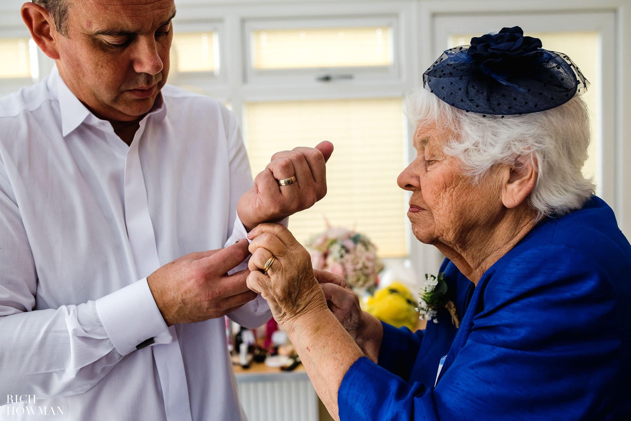 Brides Grandmother helping her son (the Brides father) do up his cufflinks on the morning of the wedding