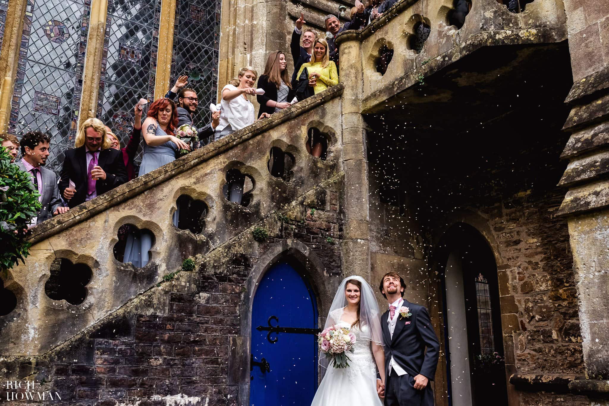 Confetti being thrown from the staircase at the Bishops Palace over the Bride and Groom