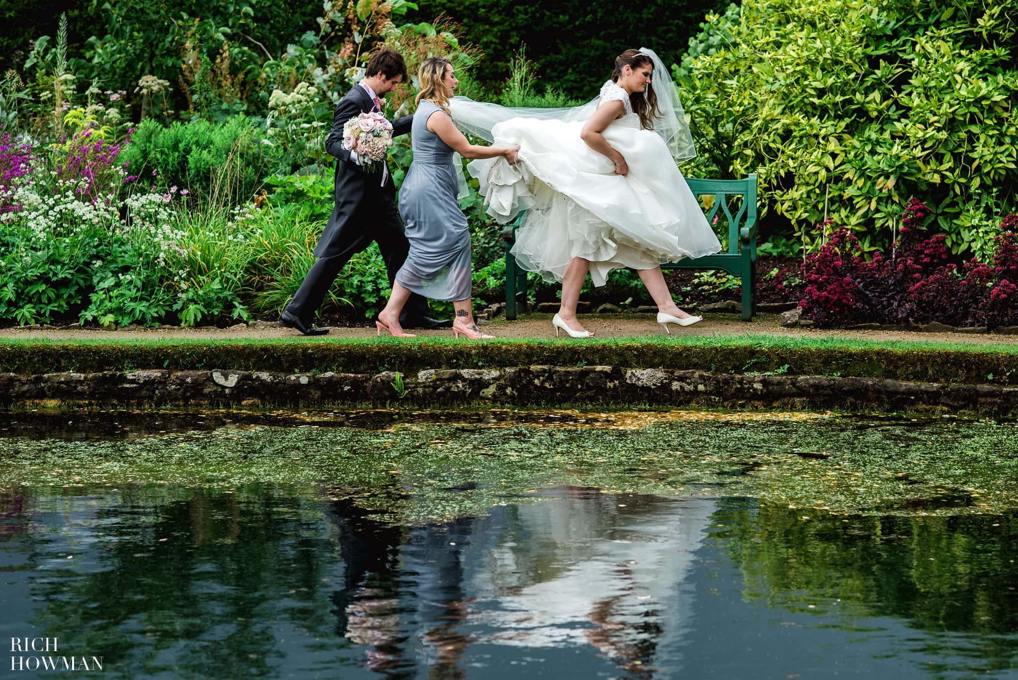 Bride and groom reflected in the lake in the grounds of the Bishops Palace