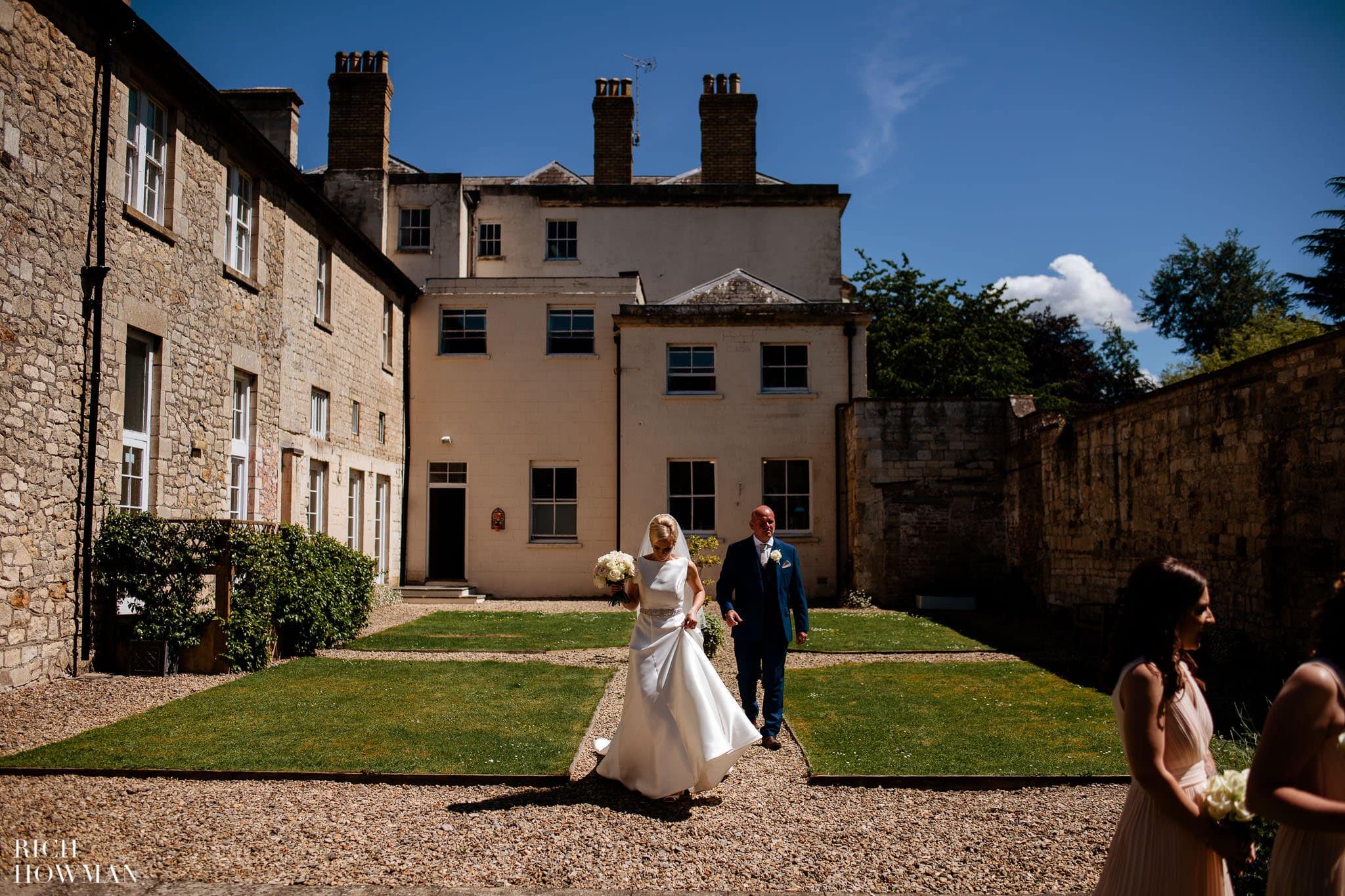 bride and groom outside manor house captured by eastington park wedding photographer, rich howman