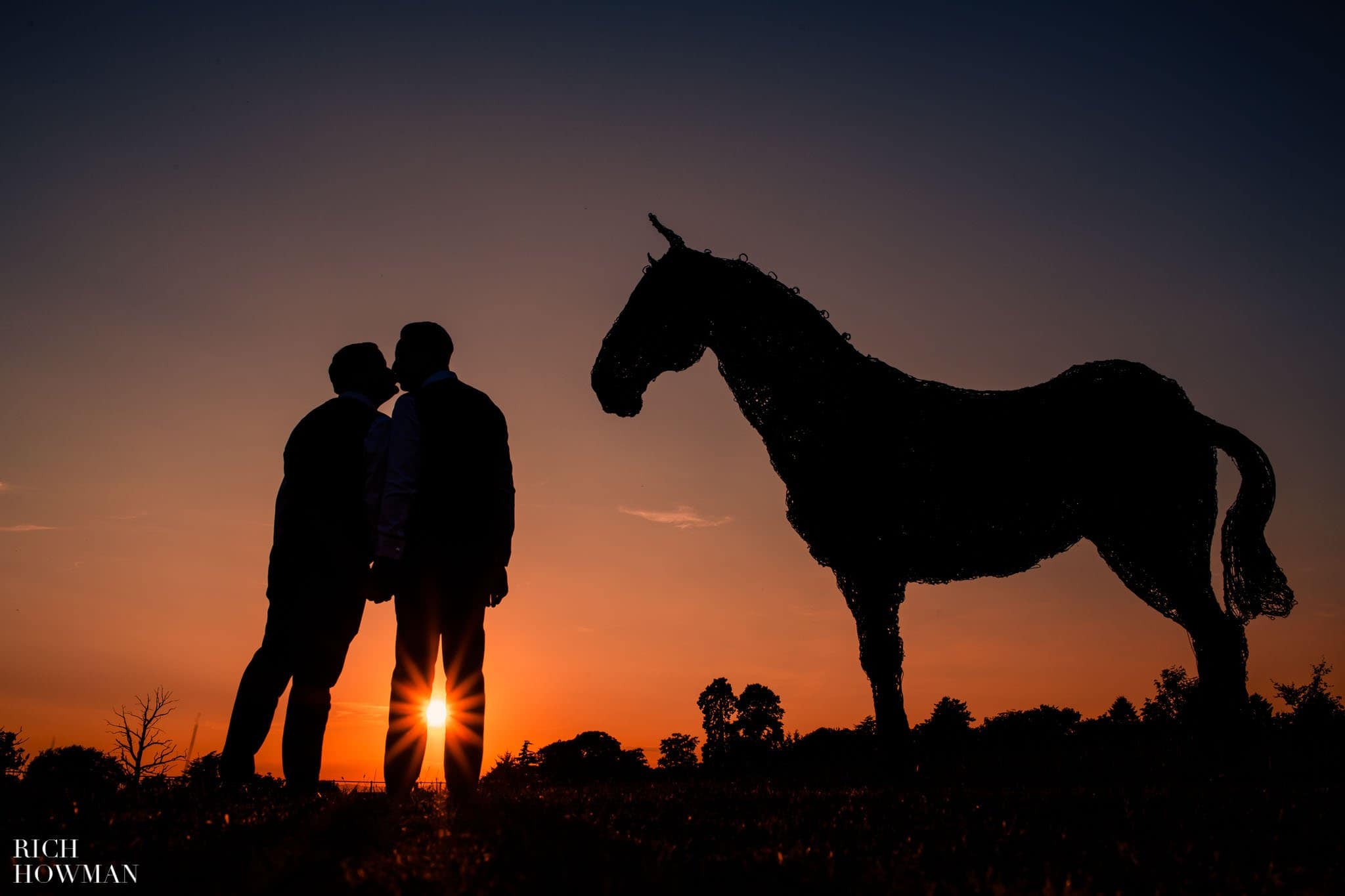 Ellenborough Park Wedding Photographer grooms kiss in front of the sunset