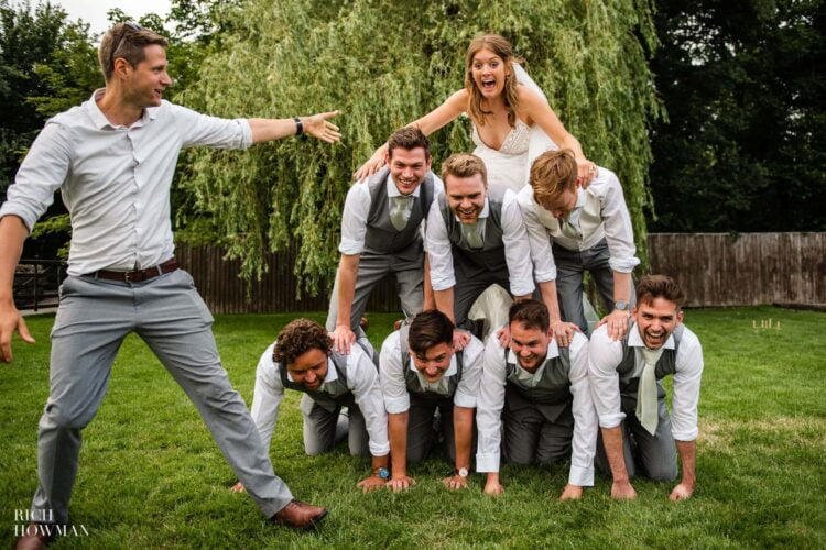 human pyramid with bride on top captured by alwick court wedding photographer, Rich Howman