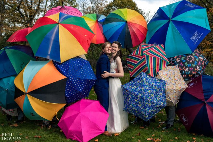 brides surrounded by a rainbow of umbrellas, captured by bath wedding photographers Rich Howman