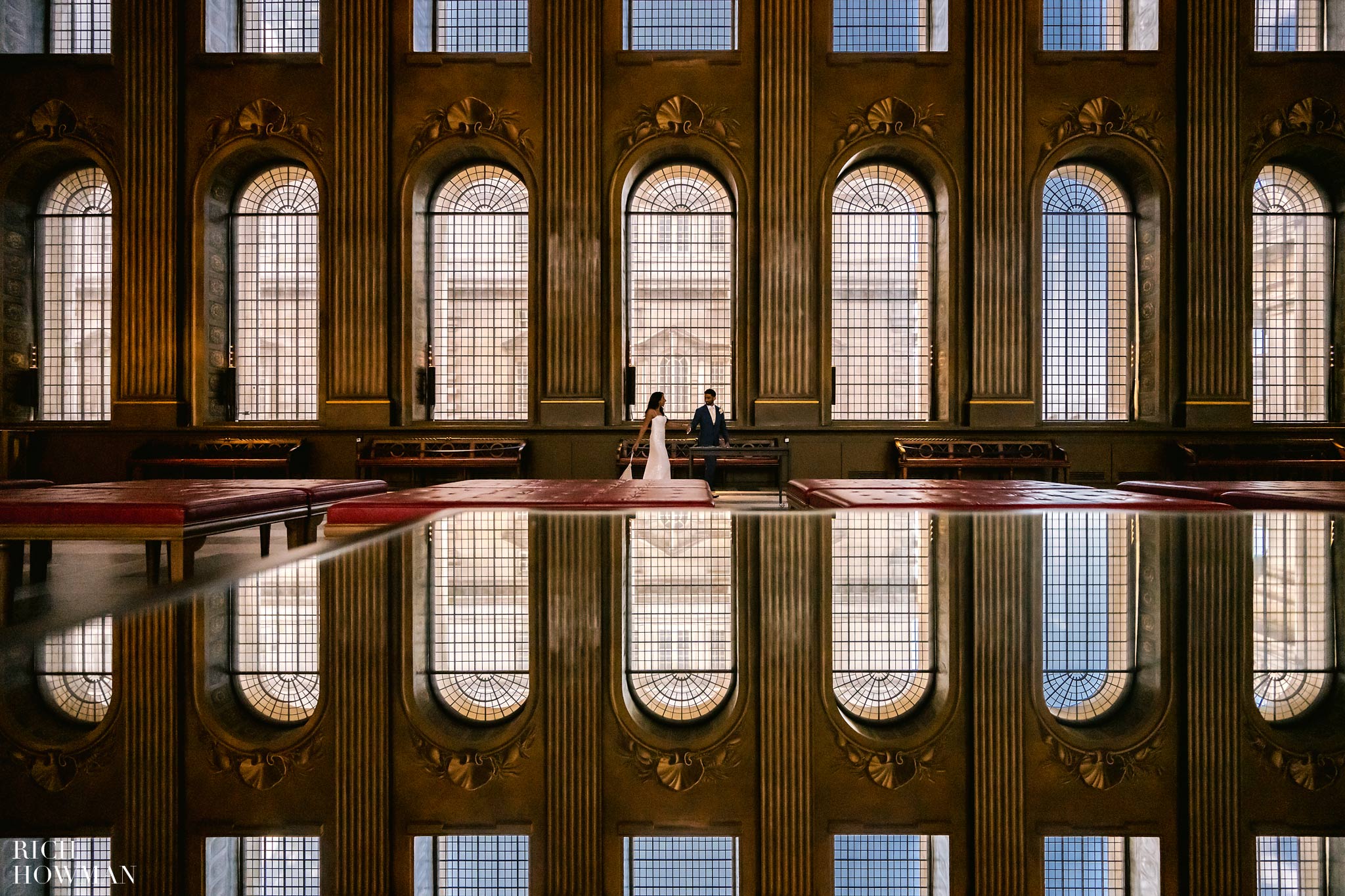 Reflections of the windows as the bride and groom take a romantic walk through the painted hall, captured by old royal naval college wedding photographer, Rich Howman.