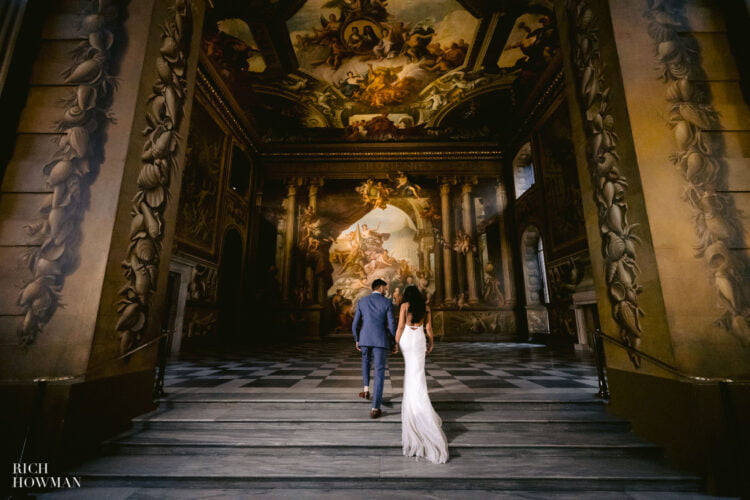 bride and groom on steps of the painted hall by painted hall wedding photographer Rich Howman