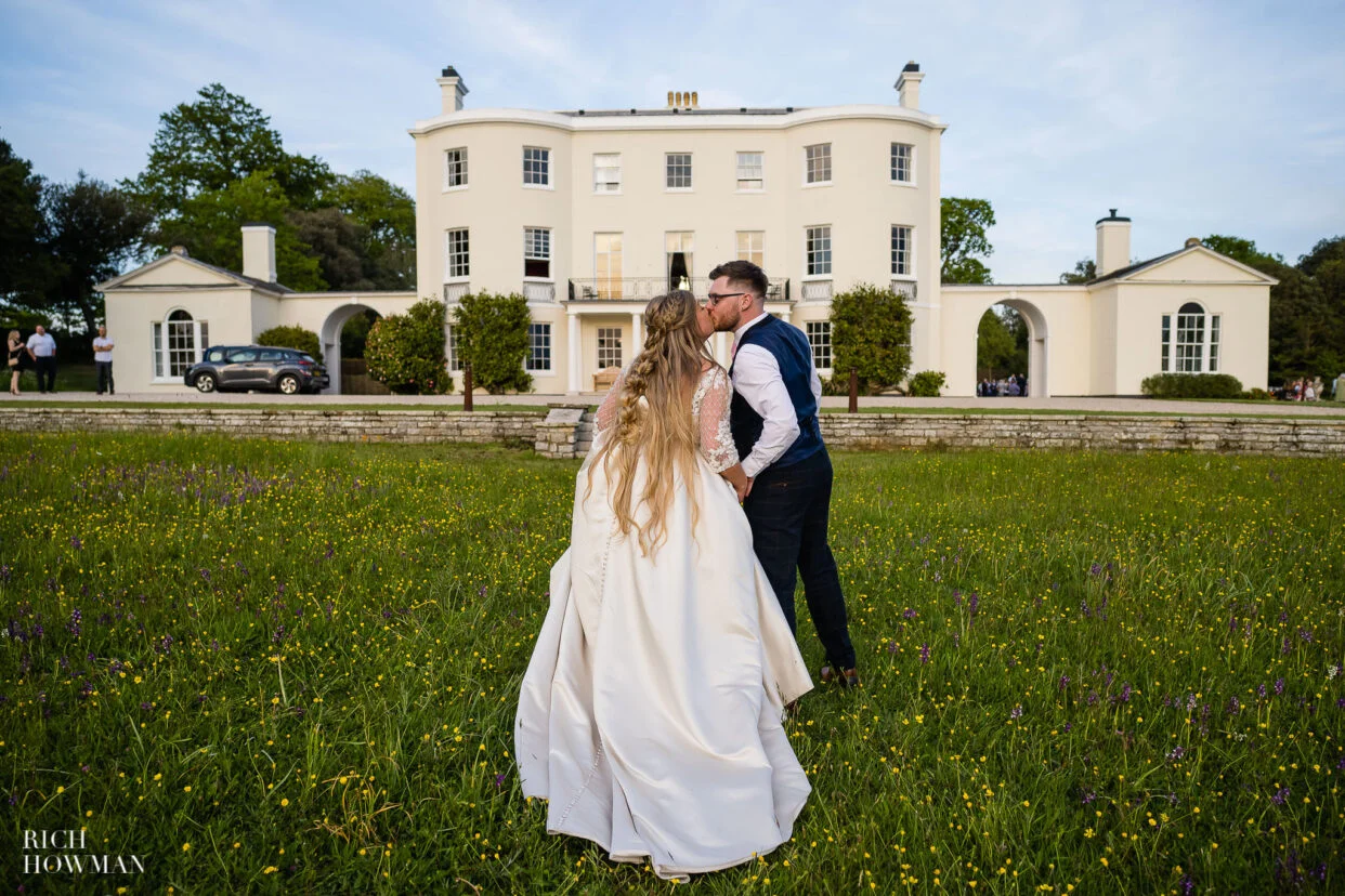 bride and groom in front of regency building by rockbeare manor wedding photographer rich howman