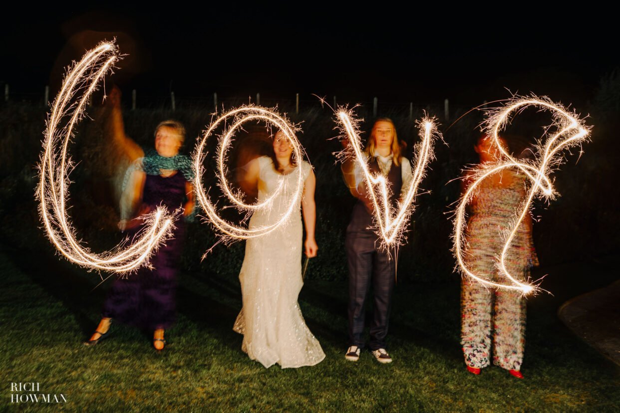 sparkler writing love captured by tower hill barns wedding photographer in Wrexham, rich howman