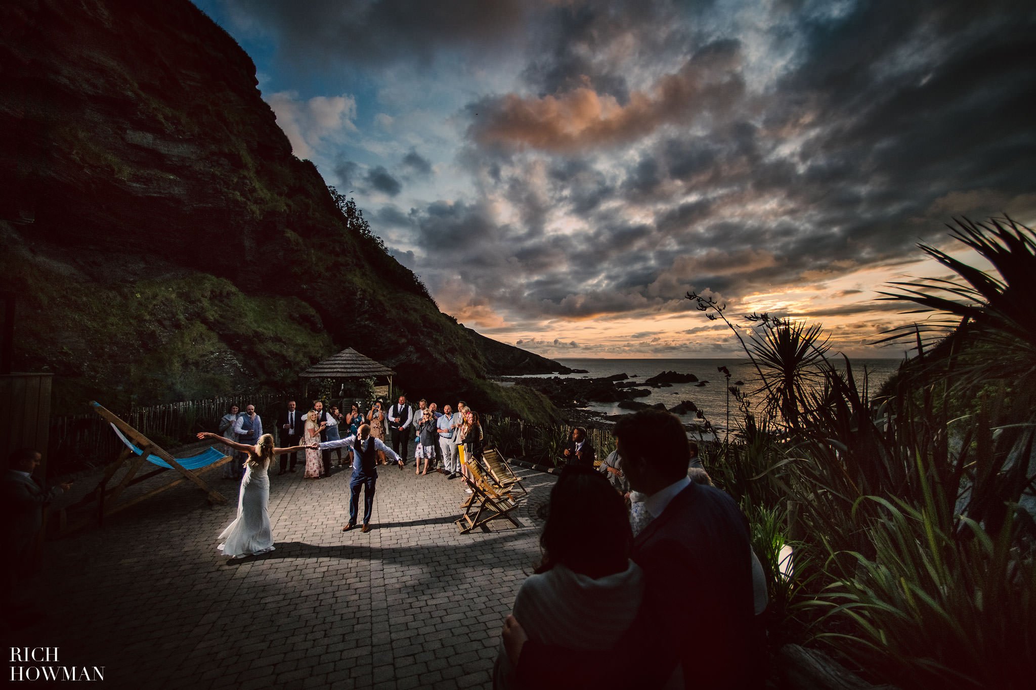 sunset first dance overlooking private beach captured by Rich howman,Tunnels Beaches Wedding Photographer in Devon