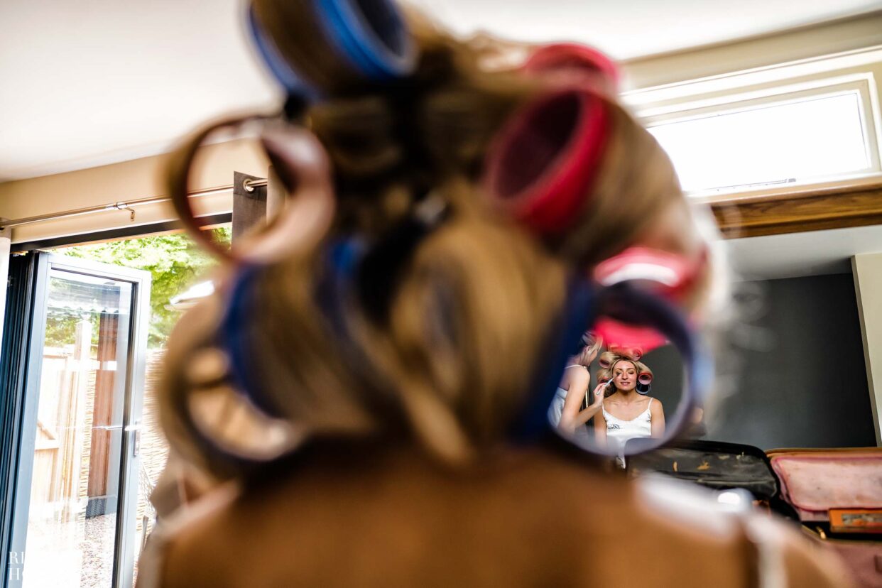bride photographed through enormous hair rollers by bredenbury court barns wedding photographer, Rich howman