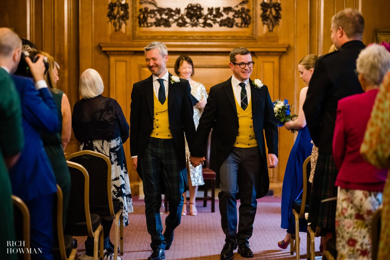 Grooms smiling as they walk down the aisle as newlyweds, captured by inner temple wedding photographer Rich Howman