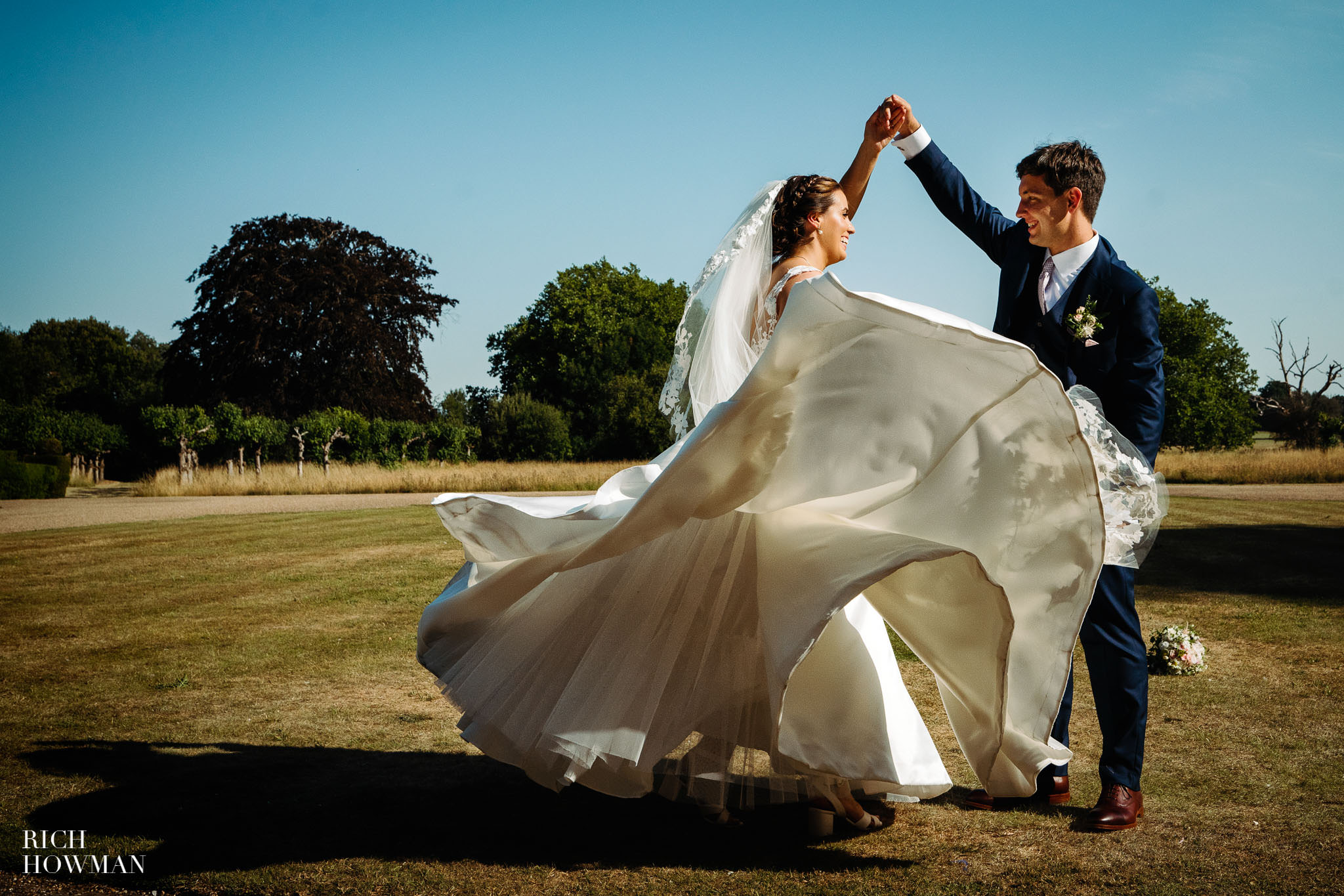 twirling bride in the summer sun, captured by hengrave hall wedding photographer, rich howman