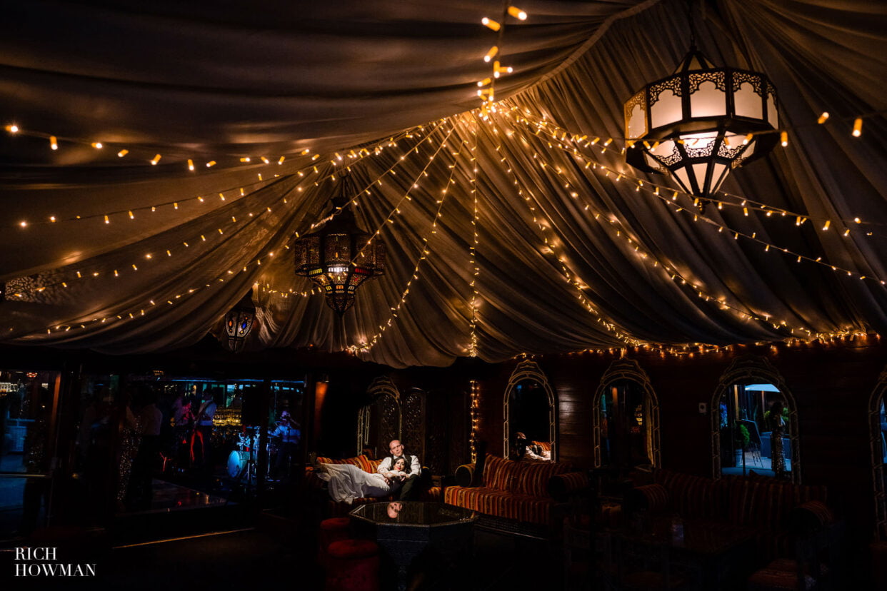 bride and groom under fairy lights, captured by crazy bear wedding photographer, rich howman
