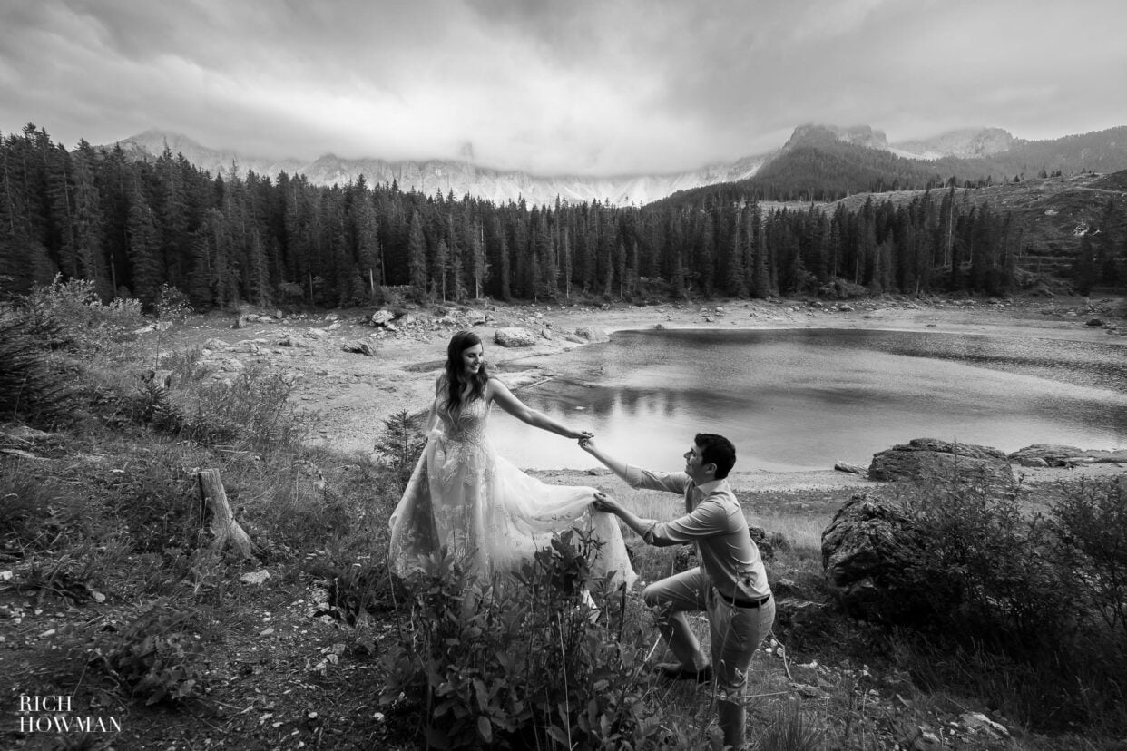 black and white portrait of couple next to a mountain lake, captured by dolomites wedding photographer, Rich Howman