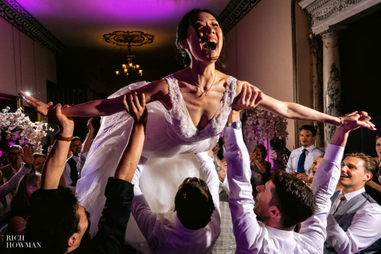 ballerina bride being lifted by wedding party, captured by Swinton Park hotel wedding photographer in Ripon, Rich Howman