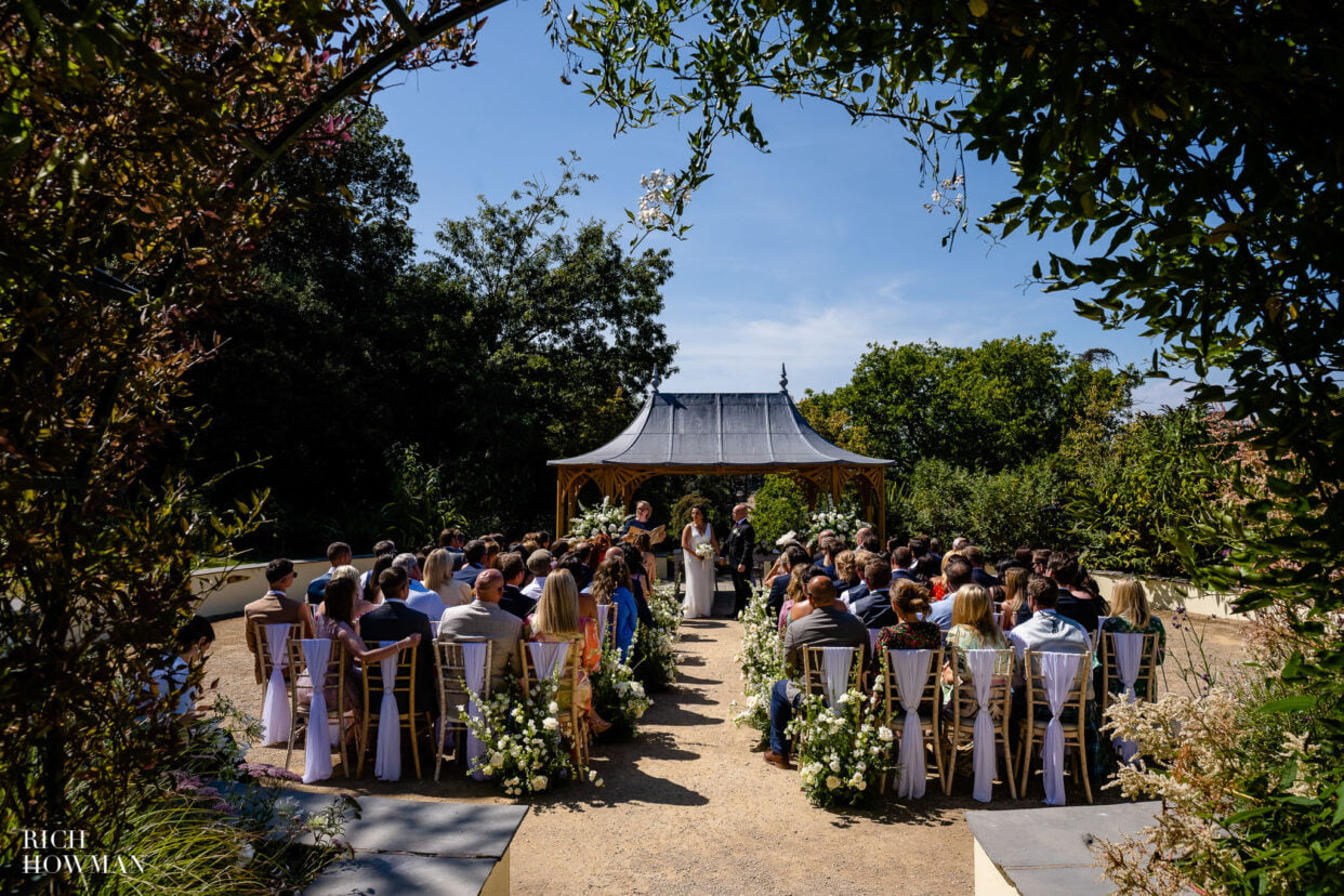 outdoor wedding ceremony, captured by clevedon hall wedding photographer Rich Howman