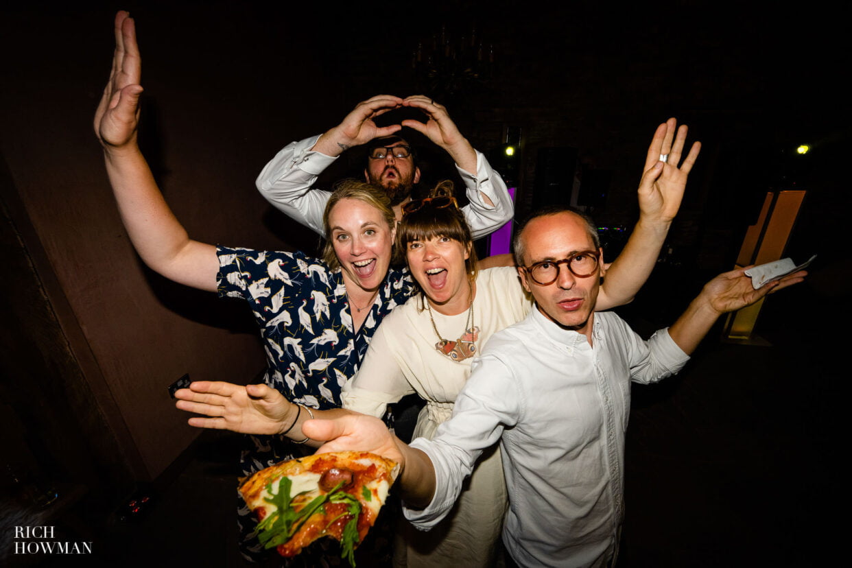 dancing the night away with pizza in hand, captured by lower house farm wedding photographer, Rich Howman
