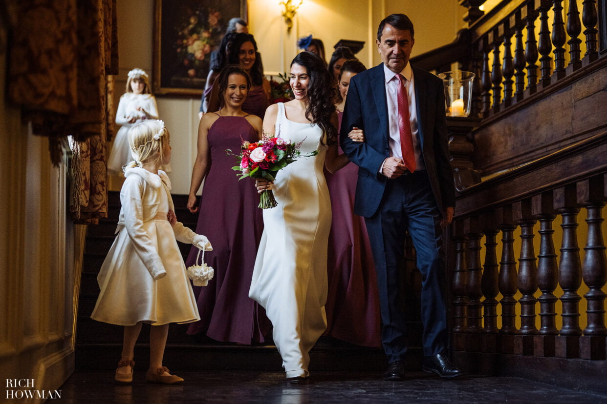 bridal party walking down the great staircase to winter Brympton house wedding