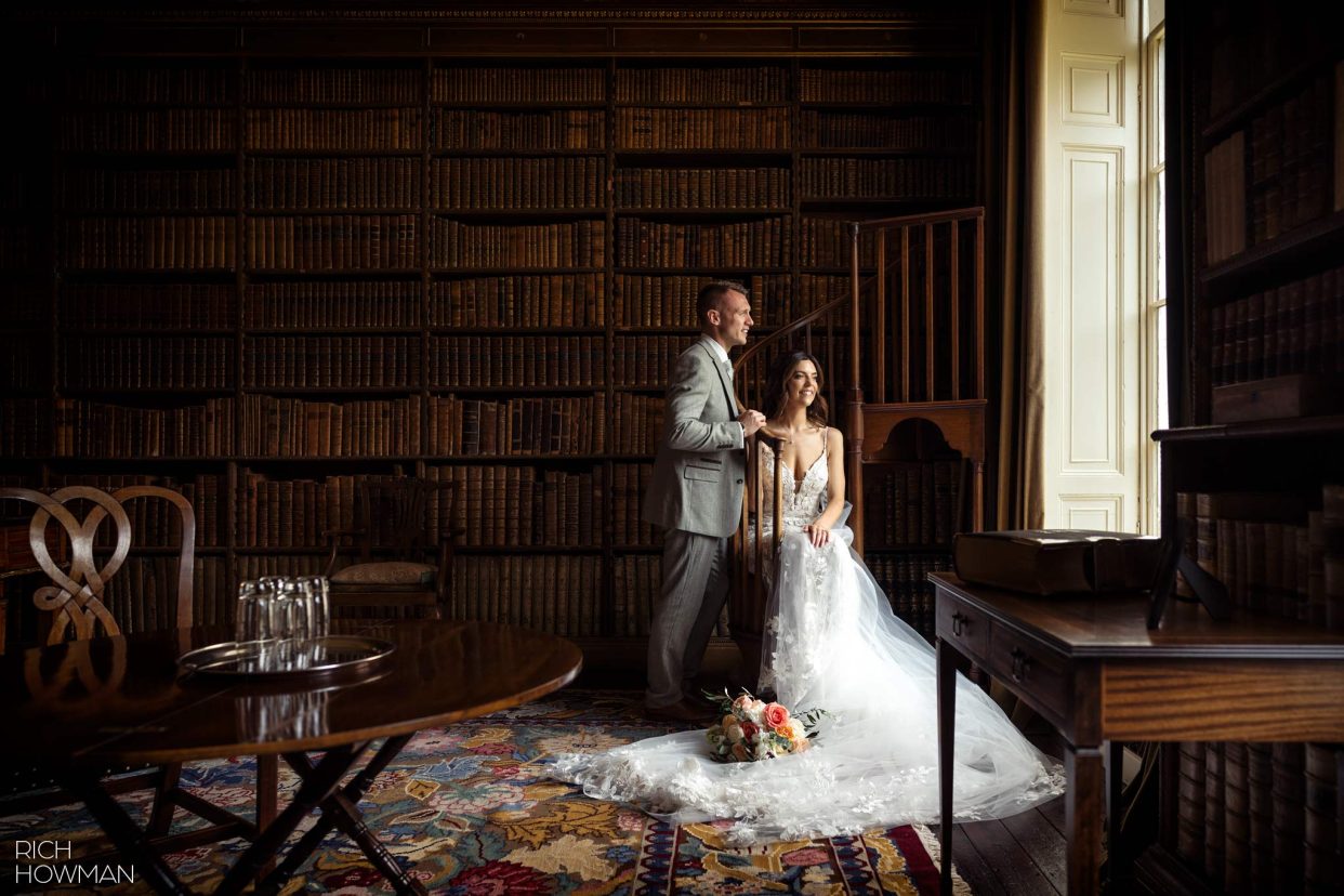 Portrait of bride and groom in window light in the library, captured by Ragley Hall wedding photographer, Rich Howman
