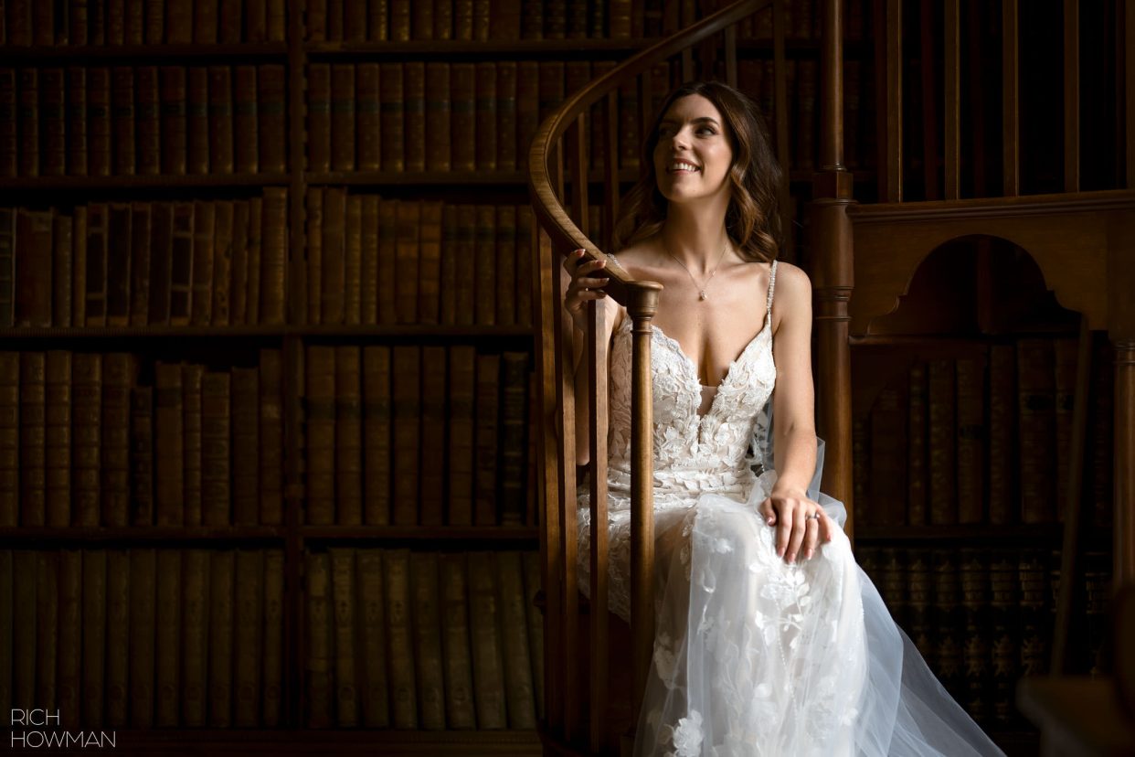 bridal portrait in soft window light on the library staircase, captured by Ragley Hall wedding photographer, Rich Howman